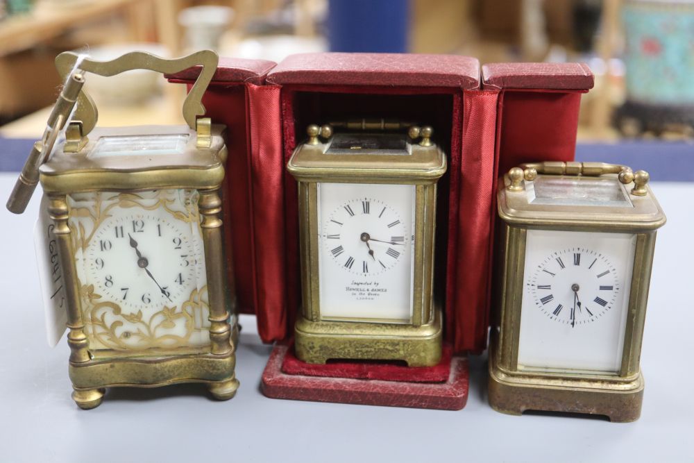 A cased lacquered brass miniature carriage timepiece and two others